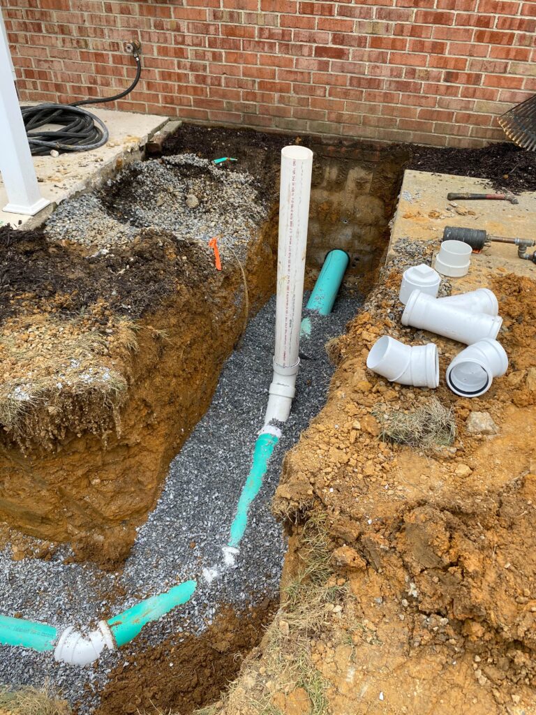 Sewer piping coming out of a house being repaired. 